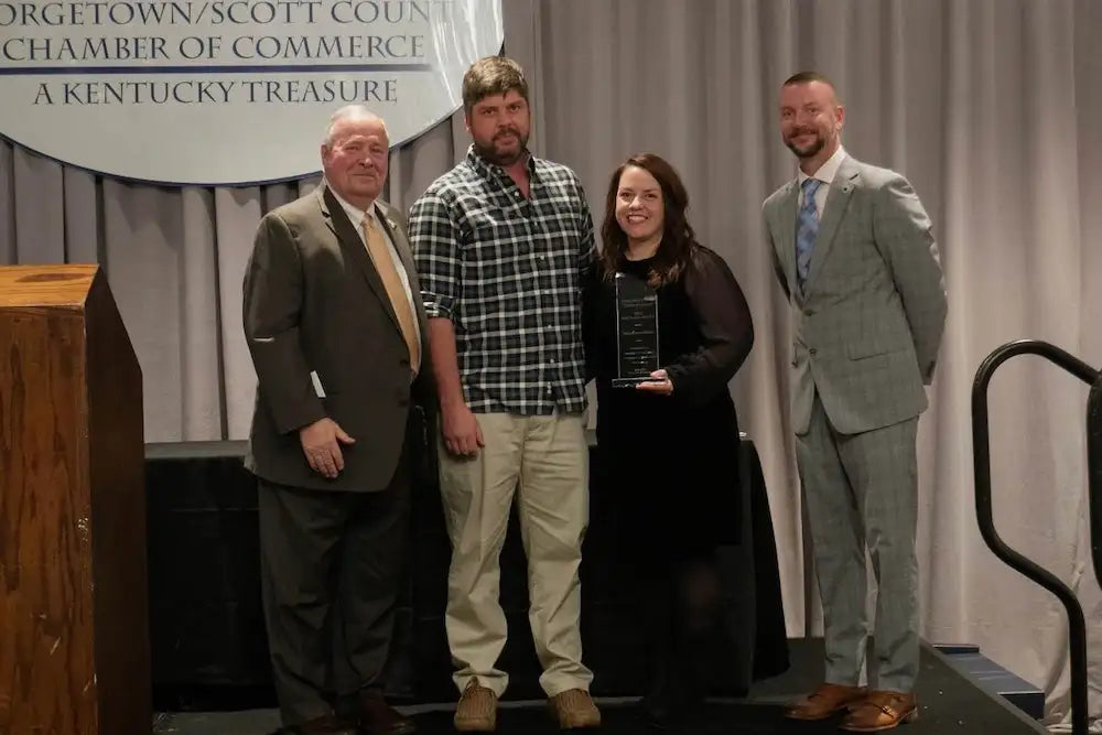 Black acrylic award with a sleek, modern design and engraved text on its surface.