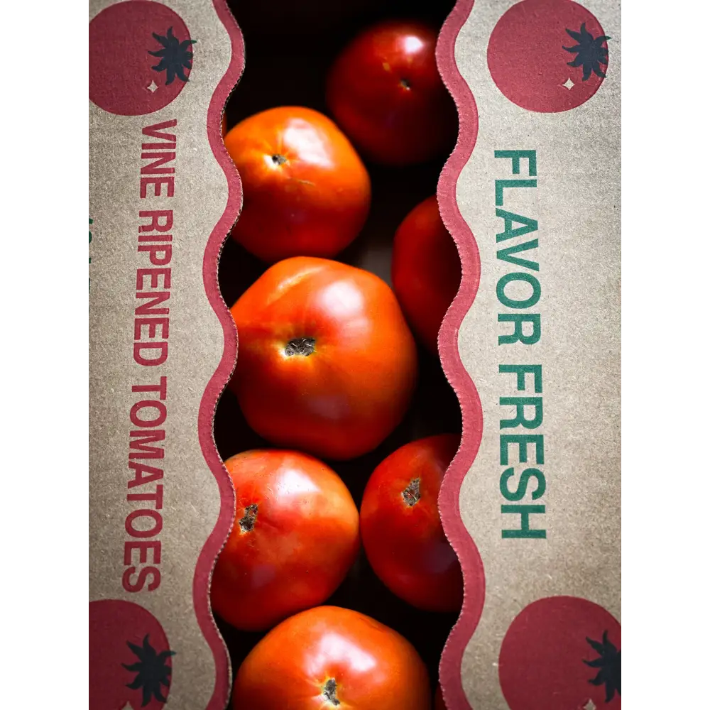 Vibrant red canning tomatoes in a rustic 25lb box perfect for csa produce boxes and home preserving